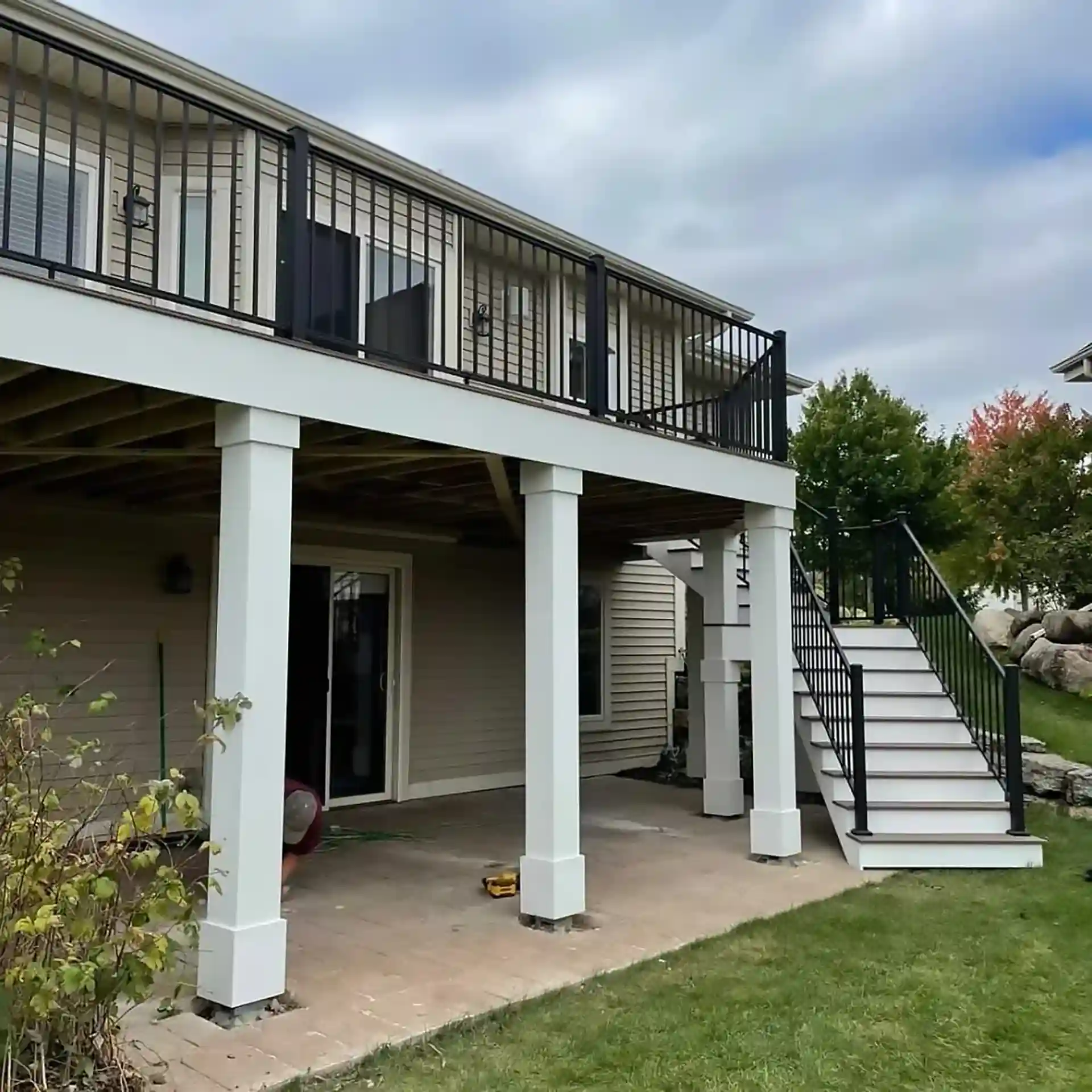 Photo of an elevated deck with a dry space patio underneath. Underdeck dryspace waterproofing allows the homeowners to enjoy more of their property.
