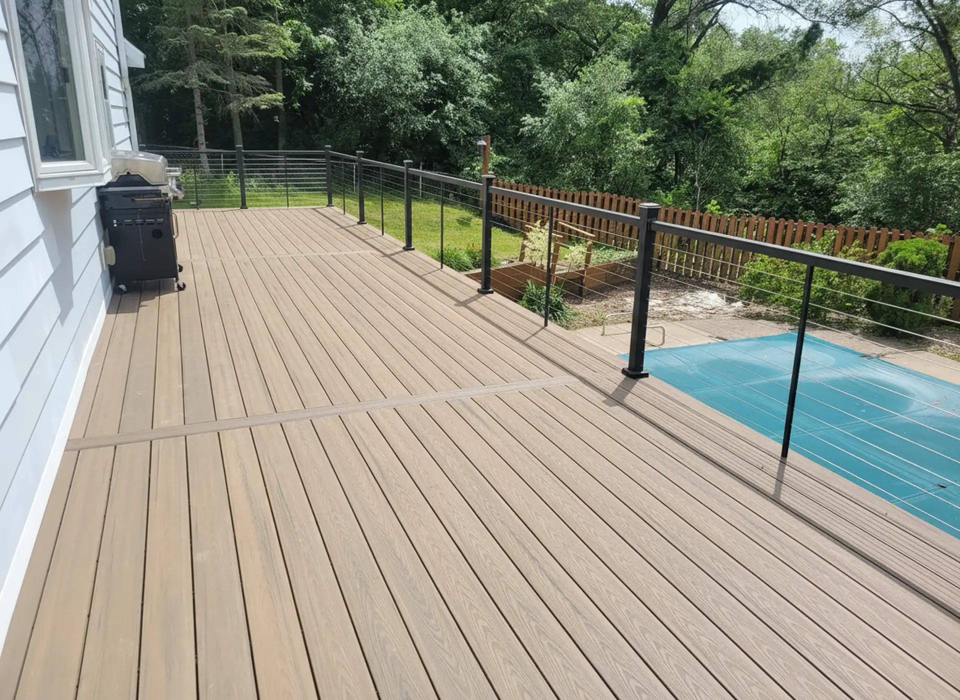 Composite poolside deck with cable rail and grill area