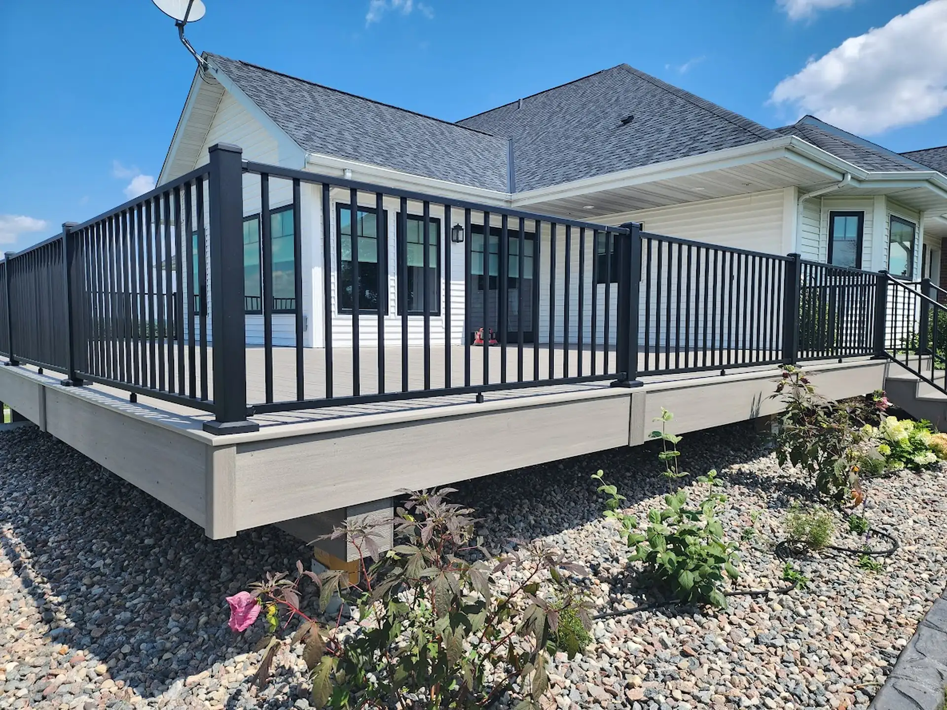 Elevated composite deck with black metal railings